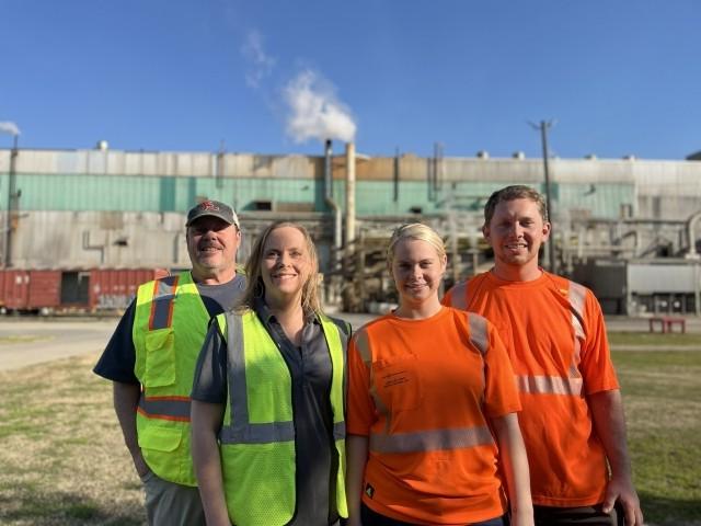 members of the Boyette family standing in front of IP facility